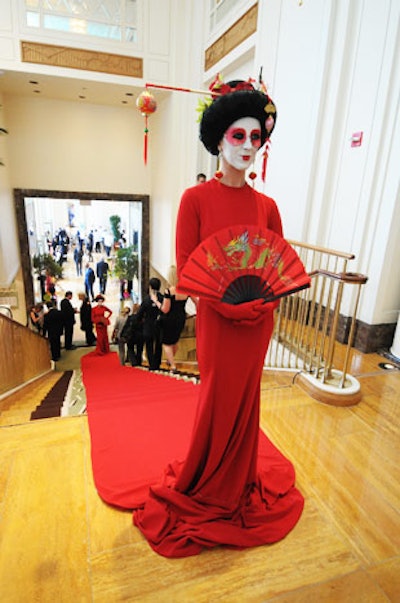A costumed geisha stood guard at the top of the staircase that leads from the lobby to the terrace and ballroom. The long train of the geisha's dress formed a red carpet down the center of the stairs.