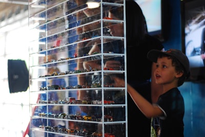 Hot Wheels displayed dozens of cars on plexiglass shelves.