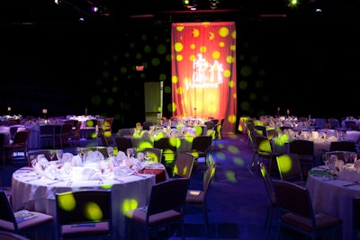 Green lighting in the main dining space illuminated the white table linens.