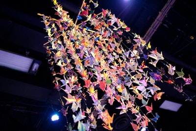 Event producers played on the space's large size by hanging paper birds from the ceiling of the 50,000-square-foot venue.