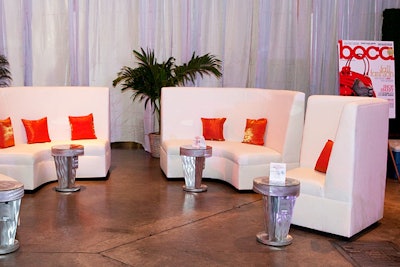 Room Service accented high-back lounge seating with orange pillows and silver tables in the V.I.P. area.