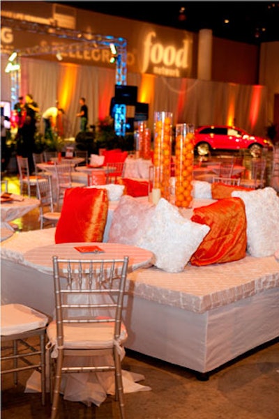 To make the orange stand out, event chair and decorator Kelly Murphy placed it against white and silver furniture and linens.
