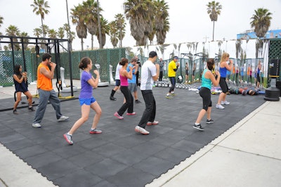 Flooring for group fitness classes in Beverly Hills covered a vacant parking lot.