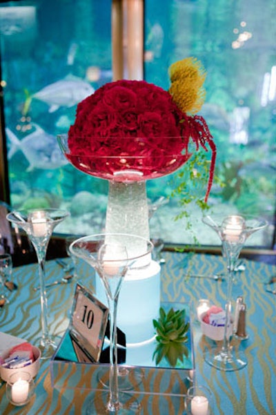 Tabletop decor in the rotunda included red roses and vessels filled with glowing liquids.