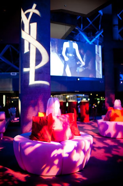 Circular white lounge chairs were arranged in one area of Roy Thomson Hall, and an Yves Saint Laurent runway show was projected in the background.