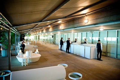 The outdoor lounge had white furniture and mirrored tables. The area was lit with lanterns.