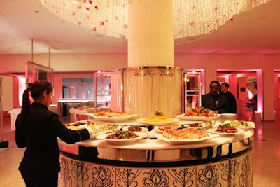 The beauty counters that usually form the lower level's retail section were emptied out for the event and the counters used as the bars and buffet stations. Pink flowers threaded into the large crystal chandeliers helped carry through the design of the other spaces.