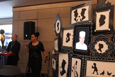 The frame-and-silhouette design printed on the event's banners also influenced the look of other decor components, including a freestanding wall with a digital screen in the center that flashed photos of the participating chefs.