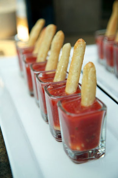 Servers circulated with summery appetizers, like cold gazpacho with garlic sticks.