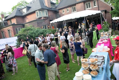 Guests mingled in the backyard of a private residence for the Serve!stock fund-raiser. Jewel-coloured linens brightened the area.