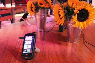 In the café, Microsoft placed the phones on patio tables beside metal buckets of sunflowers. Attendees roaming the reception could sit at the tables and play with the devices, while sipping on cocktails provided at a nearby bar.