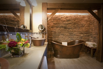 A stone wall backs the tub in the Big Thunder Suite master bathroom.