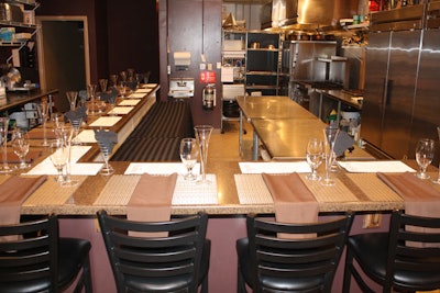 Barstools put diners at the right height to watch the chefs as they prepare the evening's meal.