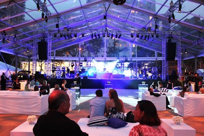 The main space for the post-reception party was held under a 13,000-square-foot tent with a clear top. An 864-square-foot glossy white dance floor sat in front of the stage, which stood at the eastern edge of the park.