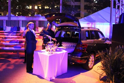 The brand's take on a tailgate party involved waiters serving Champagne out of the backs of Mercedes-Benz GL Class SUVs.