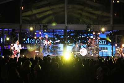 The stage for the performance was strategically placed so that guests could see the new dealership's illuminated 'Mercedes-Benz' sign behind the band as they performed.