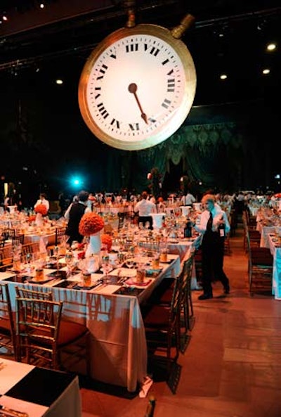 The V.I.P. dinner took place onstage in R. Fraser Elliot Hall. A large clock, part of the Alice's Adventures in Wonderland set, hung overhead.
