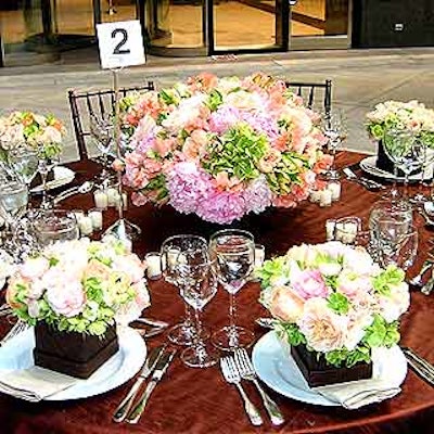 Magnolia Flowers & Events' table featured one large pastel colored centerpiece, with smaller matching bouquets at each place setting.