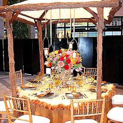 DeJuan Stroud decorated his table with a small hut accented with suspended candle holders and a rich, autumnal-colored centerpiece with roses, tulips and peonies.