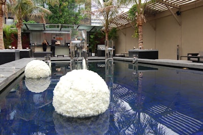 Floating votive candles and large flower balls filled the shallow reflective pool outside.