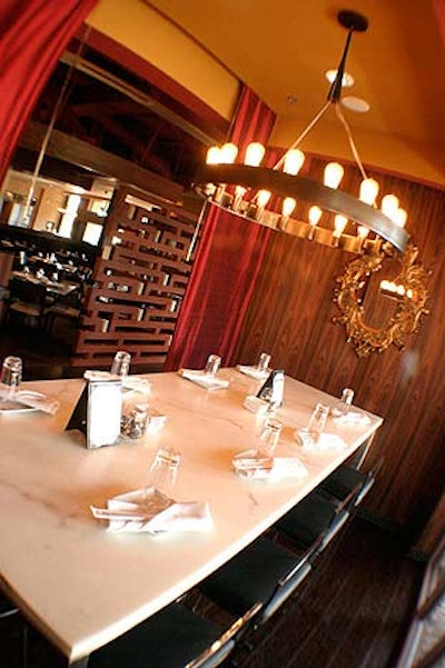Long red drapes provide privacy for groups dining at the eight-top table just off the lounge area at Dragonfly Sushi.