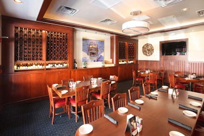 The Captain's Quarters dining room at Mitchell's Fish Market has a flat-screen TV, video conferencing capability, and dedicated controls for lighting, music, and air.