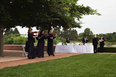 The Sirens, a trio of violinists from the Ken Arlen Orchestra, performed rock classics on the esplanade during the cocktail hour.