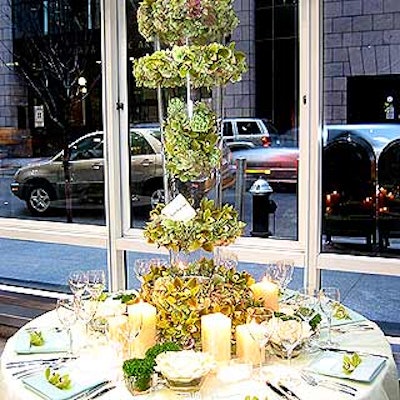 Preston Bailey placed his arrangement in a tall cylinder filled with hydrangea, viburnum and cymbidium orchids. White pillar candles surrounded the centerpiece, and an orchid was tucked into the napkins at each place setting.