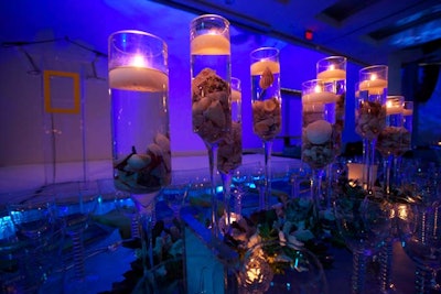 One of the various centerpiece designs used at the reception and dinner area consisted of seashells submerged in water and topped with floating candles.