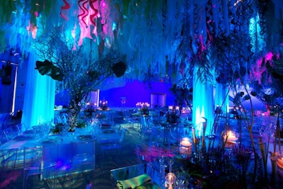 Syzygy suspended curled sheer blue, green, and coral fabric from the ceiling of the dinner area to create a seaweed look.