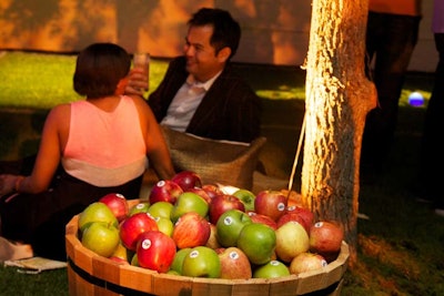 Apples filled wooden barrels scattered throughout the space, supplying an additional decor element and food for guests to snack on.