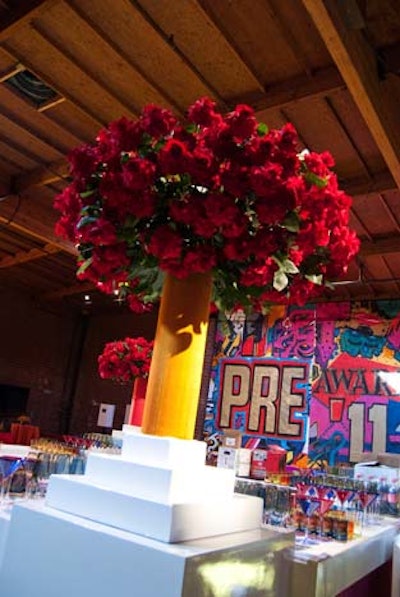 Hand-opened red roses towered from vessels on bars in the brightly colored cocktail area.