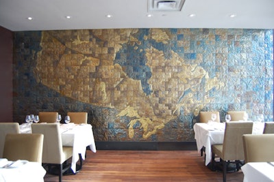 A sheet metal installation of a map of Canada covers a wall in one of Canoe's two private rooms. Both rooms have lakeside views.