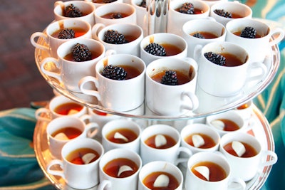 The dessert buffet had two kinds of flan cups topped with blackberries and dulce de leche.