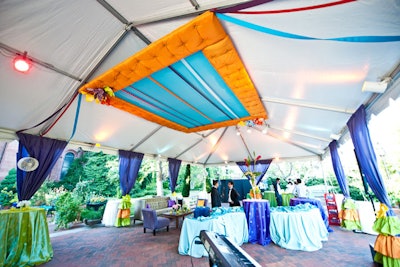 Tufted ceiling treatments adorned with ribbons decorated the top of the tent in the garden.