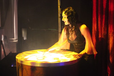 Using a drum topped with sand, a costumed artist crafted images from a corner of the stage. The act, which imitated one from the show, included creating silhouettes of people, faces, and the city skyline.