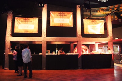 The booths set up for the food were integrated into the overall look of the event, with carnival-like signage and decorations that included a knife-throwing wheel.