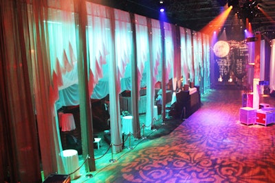 To give attendees a variety of areas to explore, Cirque du Soleil's internal event team built several environments within the theater district space. The design was intended to resemble, but not replicate, the show's visuals with long drapes, patterned projections, and other accoutrements.