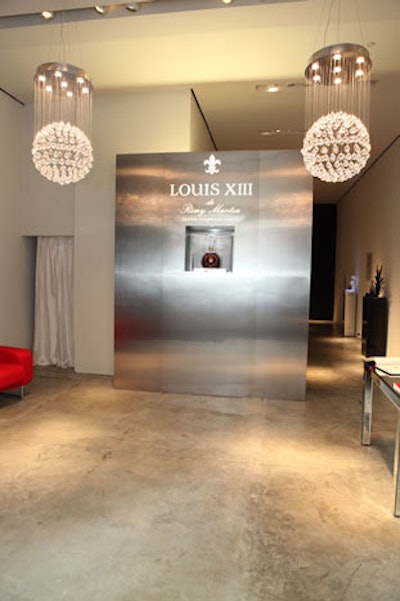 Inside the space, the branding was relatively simple and the layout uncluttered, necessitating very little change for the evening gatherings. The focal point of the site was a display of a three-liter jeroboam bottle of Louis XIII.