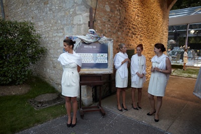 Staffers in white dresses guided guests to the 20,000-square-foot dinner tent, which was set up directly adjacent to the main estate house on a plot of land that wouldn't disturb the existing gardens.