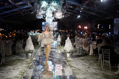 Flanked by the stage and bar, a 246-foot-long reflective runway ran the entire length of the tent and served as the site for the show.