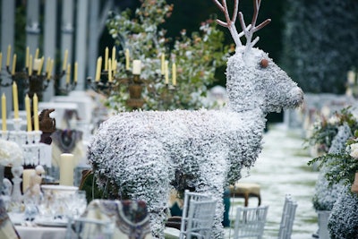 The creative team interspersed large animal-shaped topiaries frosted with fake snow throughout the dinner tent.