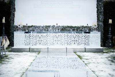 An enormous chunk of ice was carved into a bar with an intricate latticelike design.