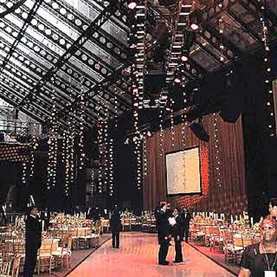 Robert Isabell suspended long, vine-like candelabras with votive candles that hung 20 feet from the ceiling, and placed 16-foot-tall candelabras against the Guggenheim Pavilion's brick walls.