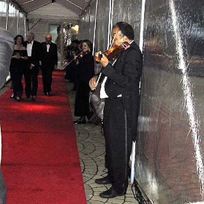 A line of violinists played for guests as they entered the tent-covered Ross Garden for cocktail hour.