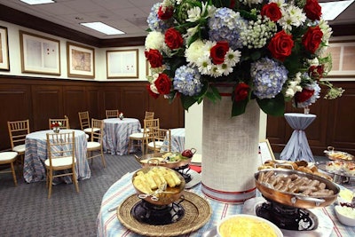 Jack H. Lucky Floral Designs provided large arrangements of blue hydrangeas, red roses, and white daisies to decorate the Washington and Jefferson rooms of the archives building for the breakfast.