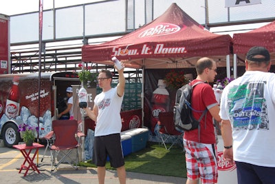 Dr. Pepper offered guests free samples from two booths. Artificial grass, coolers, and camping chairs gave the area a cottage feel.