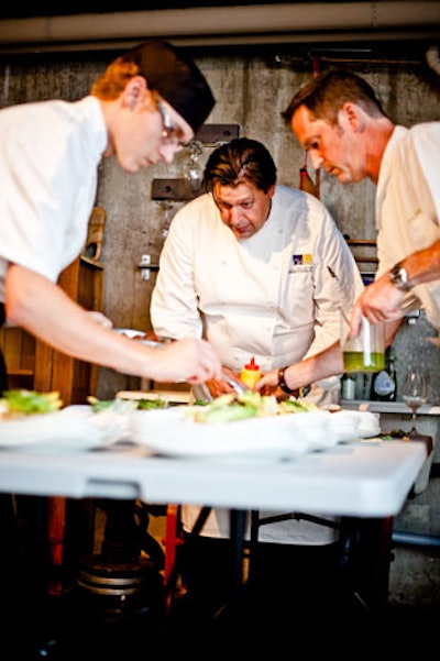 After guests helped cook the meal, chef John Cirillo (centre) and other assisting chefs put the finishing touches on the food.