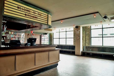 In the lobby is a bar area where a vintage marquee lists drink and food specials.
