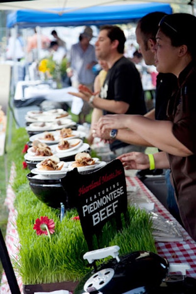 Foodlife presented Texas smoked barbecue brisket sliders in mini barbecues set atop a grassy runner.